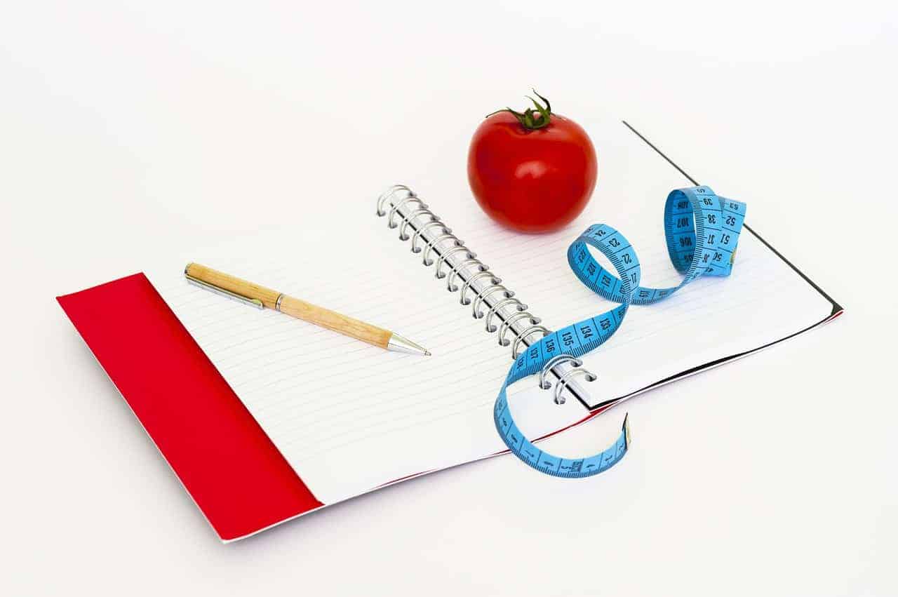 pen notebook and tomato